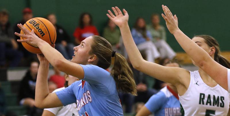 Marian Central's Sophia Meinhold drives to the basket in front of Grayslake Central's Katie Marcelain during a nonconference girls basketball on Monday, Jan. 13, 2025, at Grayslake Central High School.