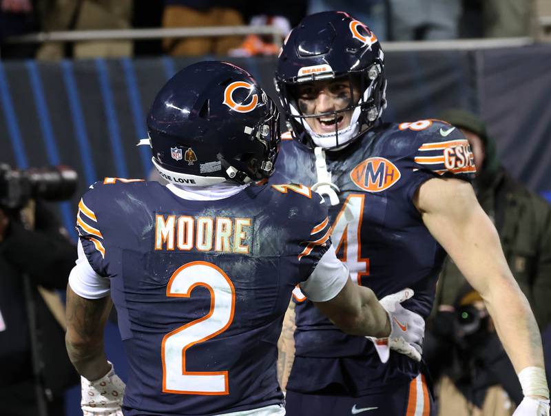Chicago Bears wide receiver DJ Moore celebrates his late go-ahead touchdown catch with tight end Colston Loveland during their NFL Wild Card game Saturday, Jan. 10, 2026, at Soldier Field in Chicago.