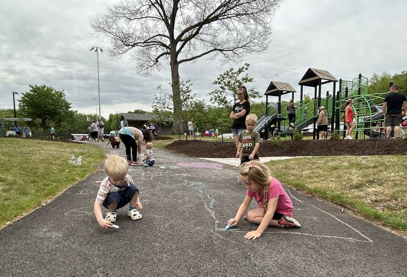 Amelia, Timothy, and Alexander Ring, of Oregon, were busy creating art with sidewalk chalk during the grand opening celebration for the newly upgraded Oregon Park East Inland Side recreation area on Monday, May 18, 2026.