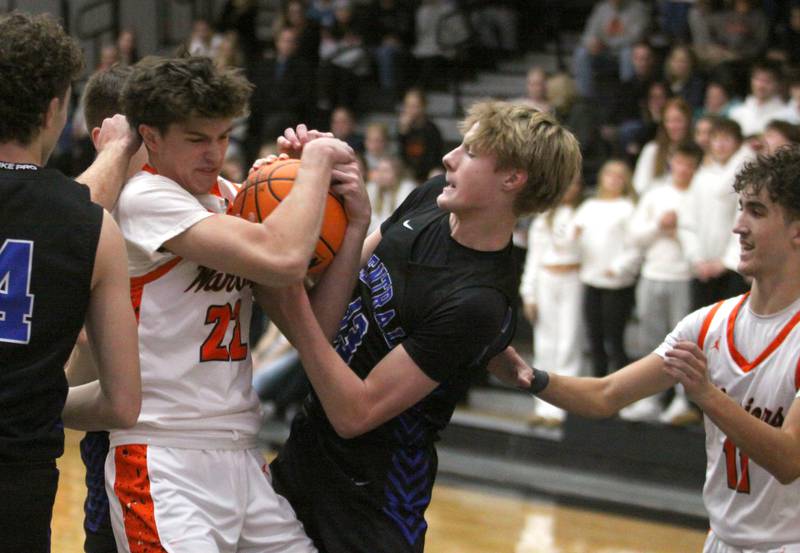 McHenry’s Blake Renfro, left, tussles with Burlington Central’s Declan Wilson for the ball in varsity boys basketball on Friday, Dec. 5, 2025, at McHenry Community High School in McHenry.
