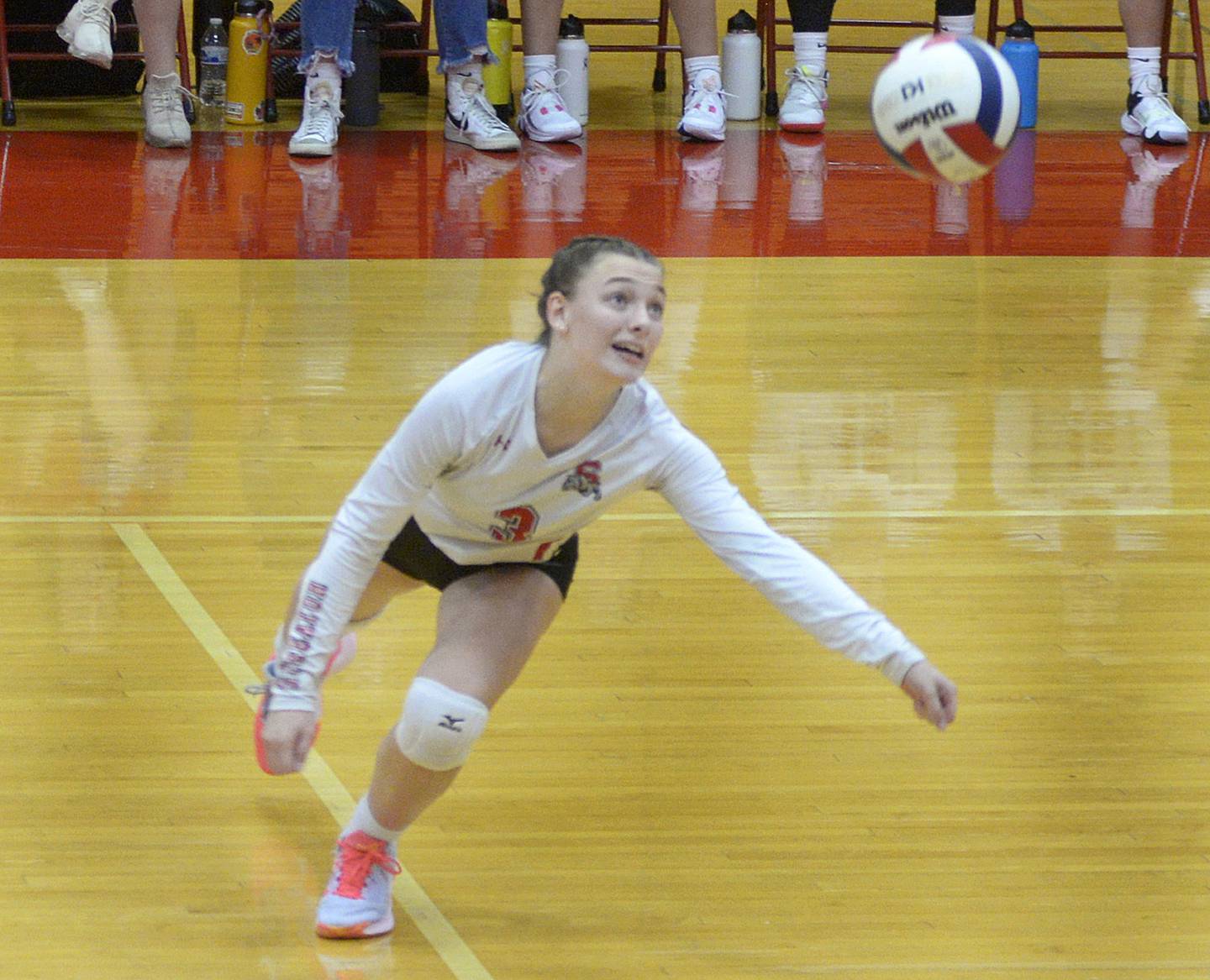 Streator’s Emma Rambo reaches to catch up to a spike against Lisle in the second set Tuesday at Streator.