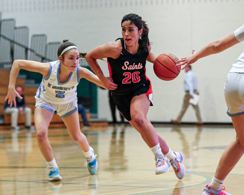 St Charles East's Alexis Maridis (20) drives down the lane at the York Thanksgiving Tournament. Nov 13, 2023.