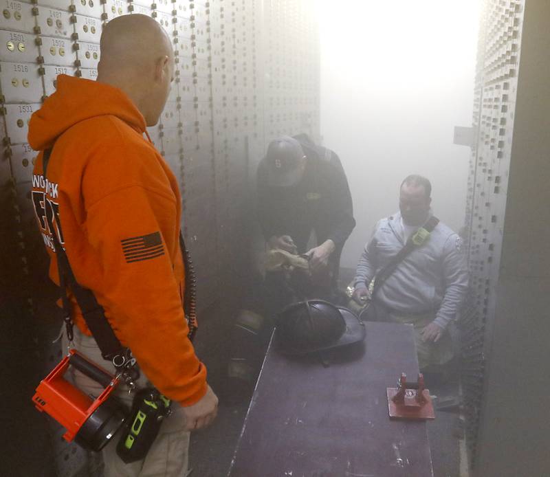 Training instructors prepare an injured firefighter training exercise on Tuesday April 15, 2025, during a RIT crew and chief divisional drill with other firefighters from area departments in a former bank building in Downtown McHenry.