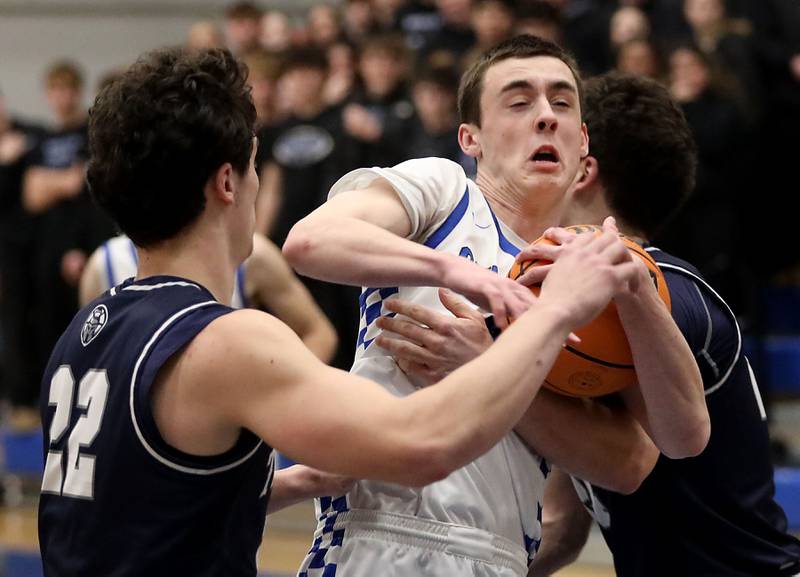 Burlington Central's Patrick Magan tries to hang on the ball as he tries to drive the plane aganst Cary-Grove's Adam Bauer during a Fox Valley Conference boys basketball game on Friday, February. 6, 2026, at Burlington Central High School.