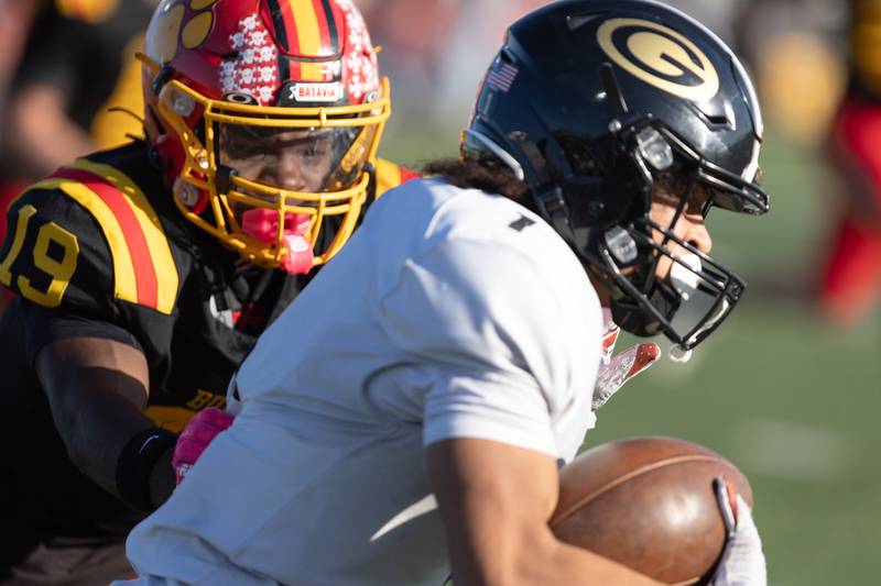 Batavia's Sai'mar Howell tackles Glenbard North's Zechariah Morris at the Class 7A Quarter Final on Saturday, Nov.15,2025 in Batavia.