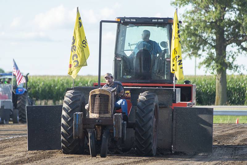 Adam Betz hauls the sled down the track Thursday, July 28, 2022 during the 4750 tractor class pulls at the Lee County 4H fair.