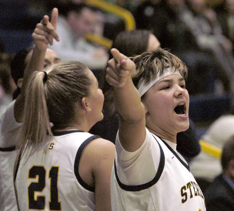 Sterling record breaker Joslynn James and her older sister Jaelynn (21) cheer on their team from the bench. Sterling girls basketball hosted Geneseo at Musgrove Fieldhouse in Sterling. The action took place on Thursday, December 11, 2025.
