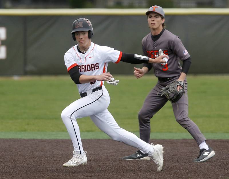 McHenry’s Carver Cohn fakes a effort to steal third base as Crystal Lake Central's James Dreher covers the move during a Fox Valley Conference baseball game on Friday, May 2, 2025, at McHenry High School.