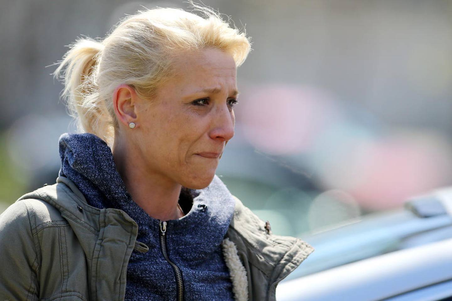 JoAnn Cunningham, mother of missing 5 year old Andrew "AJ" Freund, holds back tears April 19, 2019, as she talks with the media outside Cunningham's home on Dole Avenue in Crystal Lake.