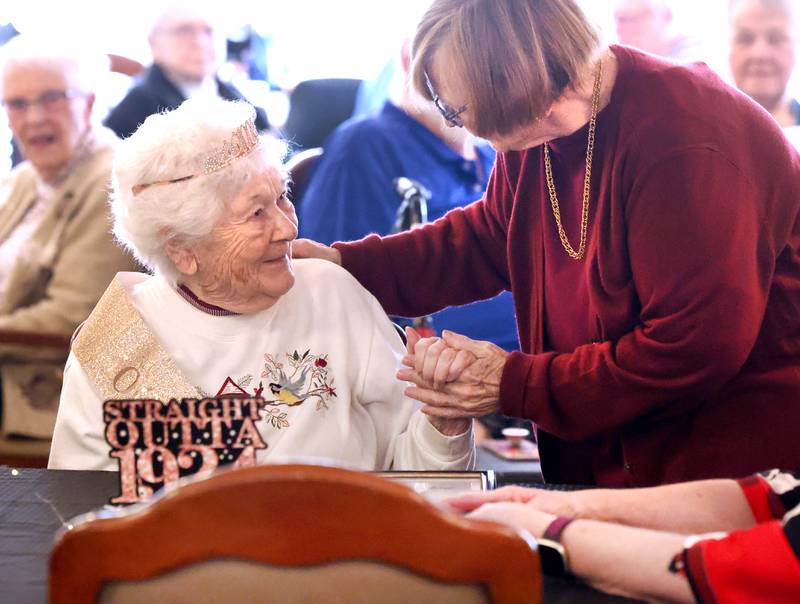 Heritage Woods of DeKalb resident Phyllis Fawcett, is greeted by friends during her surprise 100th birthday party Thursday, March 21, 2024, at Heritage Woods.