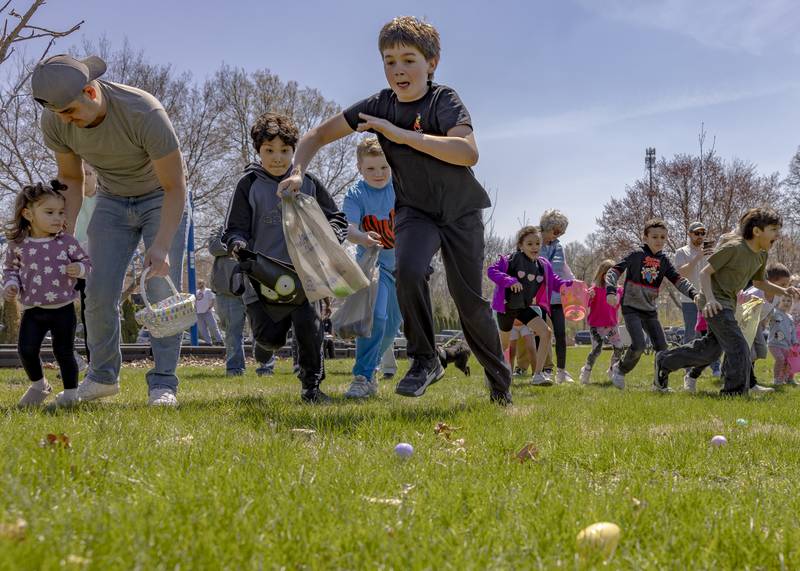 Egg hunt participants take off running after the countdown during the Easter egg hunt on April 12, 2025 at Centennial Park in Peru.