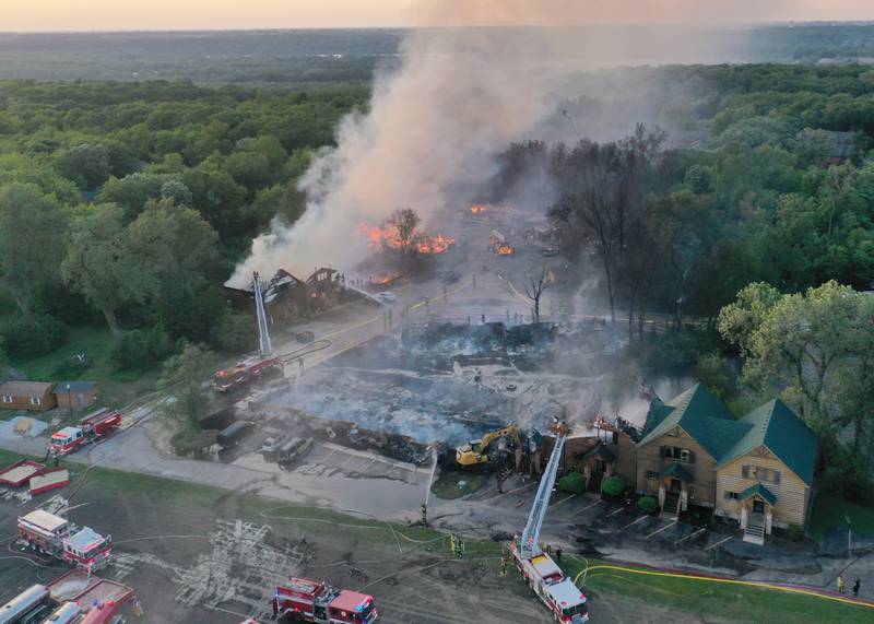 Firefighters fight a five-alarm fire on several cabins at the Grand Bear Resort on Monday, May 30, 2022 in Utica. A total of 57 fire departments and 13 MABAS division assisted at the scene, said Drew Partain, assistant Utica fire chief. Seven cabin structures have been affected, which totals to 28 units.
