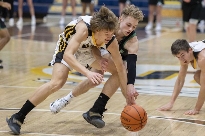 Rock Falls’ Gavin Sands works against Hinsdale South’s Nate Marcopulos for a loose ball Monday, Jan. 10, 2023 at Sterling High School’s MLK Classic basketball tournament.