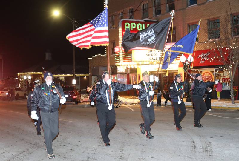 Princeton American Legion members carry the colors down Main Street during the "Night of Lights" parade on Friday, Dec. 5, 2025 downtown Princeton. The event featured the Christmas tree lighting at Veterans Park a lighted Christmas parade down Main Street,  Living Windows, a Candy Cane Hunt, and visits with Santa.