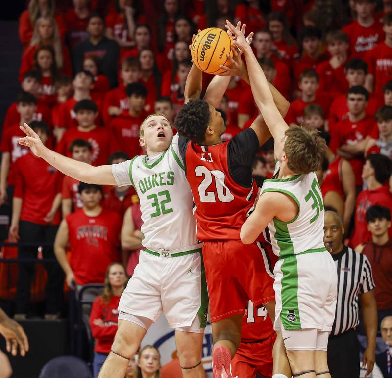 York’s Jackson Rennick (32) blocks a shot by Marist's Kendall Meyers (20) during the IHSA Class 4A boys basketball state semifinal Friday, March 13, 2026 at the State Farm Center in Champaign.