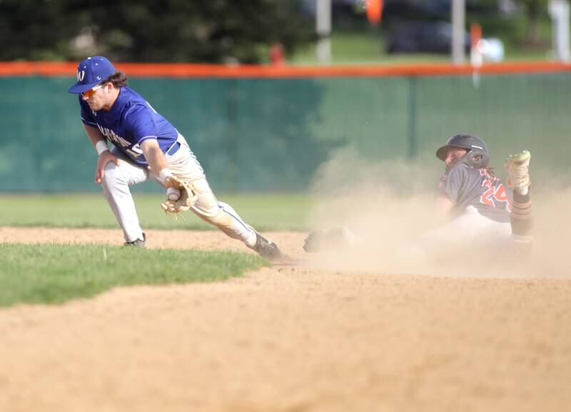 Wheaton North’s Tyler O’Connor (left) attempts to tag out St. Charles East’s Jake Zitella at second base during a game in St. Charles on Monday, May 15, 2023.