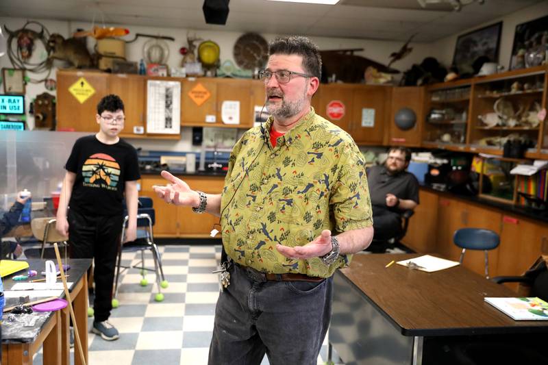 James Rowe, a special education teacher for 11th and 12th graders at Clare Woods Academy in Wheaton and a Golden Apple finalist, works on a science lesson with his students.