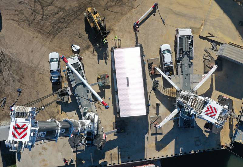 Workers prepare to hoist a 300,000 pound boiler made by the Cleaver-Brooks company in Lincoln Neb. on Wednesday Dec. 13, 2023 at Marquis Energy in Hennepin.. The boiler was transported by barge to to Hennepin from Nebraska using the Missouri River, Mississippi River and Illinois River. Marquis Energy is expected to receive several boilers within the next 12 months.