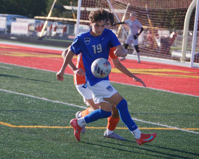 St. Charles North's Joey Turi looks to keep control of the ball against St. Charles East's Volodymyr on Thursday, Sept. 25, 2025 in Batavia.
