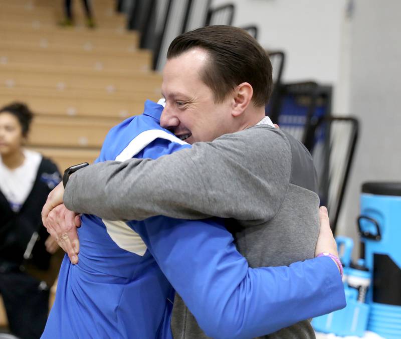 St. Charles North Head Coach Mike Tomczak (right) gets a hug following the North Stars’ Class 4A St. Charles North Regional final win over Wheaton North on Thursday, Feb. 16, 2023.
