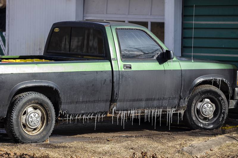 Ice forms on a nearby vehicle Monday, Jan. 20, 2025, after local departments battled a fire at a home in Sterling. Firefighters faced frigid temperatures during the Sunday fire.