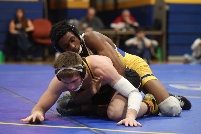 Joliet Central’s Mark Bew works over Joliet West’s Tristan Radeke in the 165-pound weight match at Joliet Central on Friday, Jan 31, 2025.
