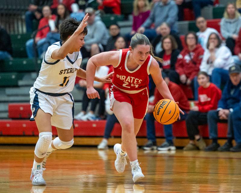 Ottawa's Kennedy Kane (24) dribbles ball down court as Joslynn James (11) of Sterling defends at hip during Regional Championship game on Thursday, Feb. 19, 2026 in Sellett Gymnasium at L-P High School.