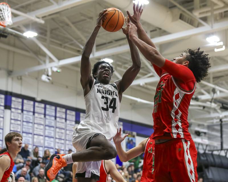 Kaneland's Jeffrey Hassan (34) puts up a shot during their Plano Christmas Classic semi-final basketball game between Kaneland at LaSalle Peru Monday, Dec 29, 2025 in Plano.