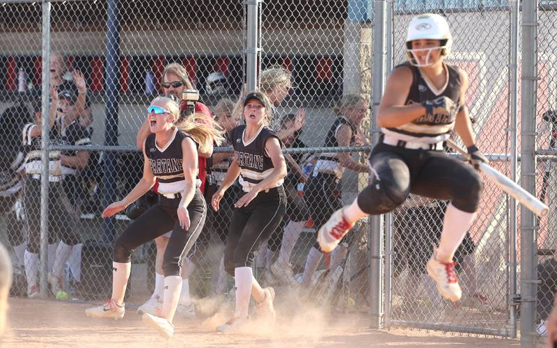 Sycamore players celebrate as the tying run crosses the plate in the bottom of the seventh during their Class 3A sectional championship game against Sterling Friday, June 2, 2023, at Belvidere North High School.