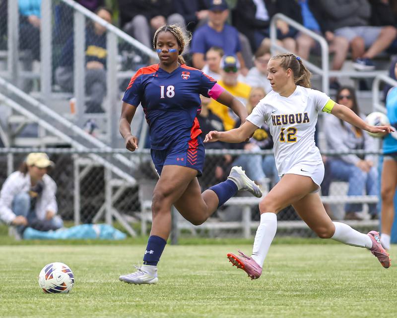 Oswego's Jordyn Washington (18) and Neuqua Valley's Addison Guskey (12) chase down the ball during Class 3A regional final soccer match between Neuqua Valley at Oswego on Saturday, May 23, 2026 in Oswego.