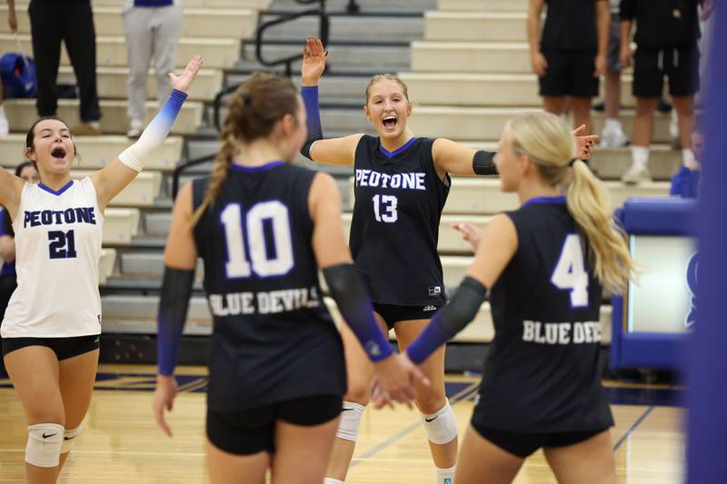 Peotone's Mia Connolley, center, and Ella Stupegia, left, celebrate a point during the Blue Devils' loss in three sets, 19-25, 25-19, 25-21, to Manteno on Tuesday, Sept. 23, 2025.