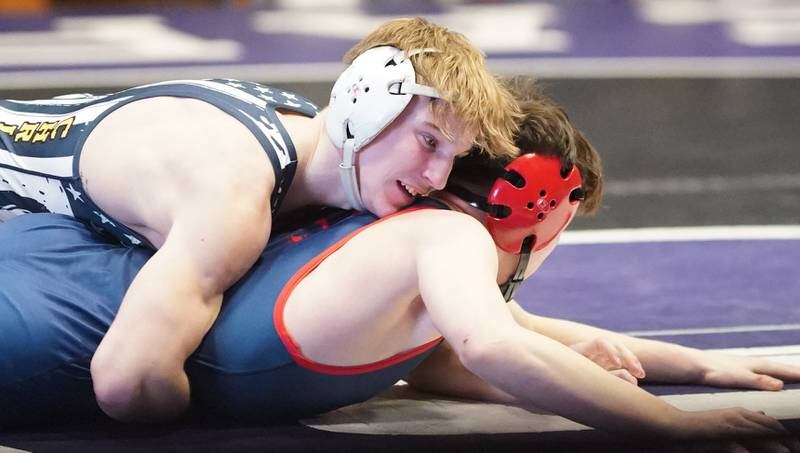 Yorkville Christian’s Ty Edwards (top) competes in a 132 pound championship match against St. Rita’s Nino Protti during the Reaper Classic Wrestling meet at Plano High School on Saturday, Dec 9, 2023.
