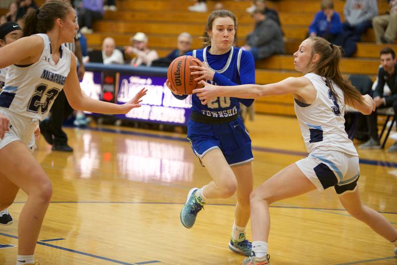 Lyons Ella Ormsby splits Downers Grove South's defense of Addison Bryant (23) and Emily Petring (3) at the West Suburban Conference Crossover Championship on Wednesday, Feb.8,2023 in Addison.
