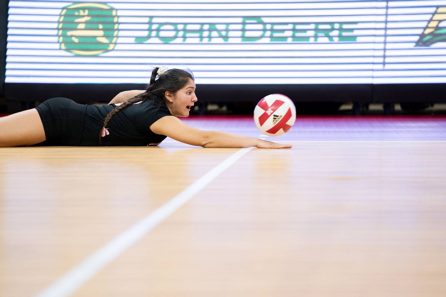 Nebraska libero Lexi Rodriguez makes a pancake dig during a match against Indiana earlier this season.