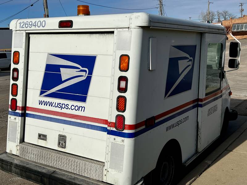 A mail truck sits parked outside the United States Post Office in Dixon, Illinois.