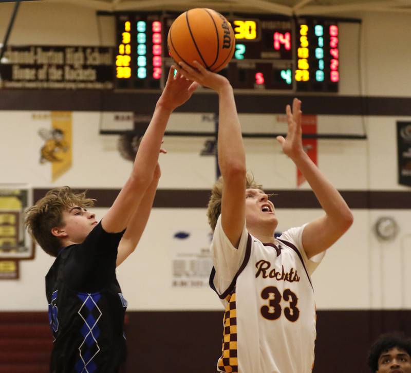 Woodstock's Maxwell Beard tries to block the shot of Richmond-Burton's Luke Robinson during a Kishwaukee River Conference basketball game on Wednesday, Feb. 5, 2025, at Richmond-Burton High School.
