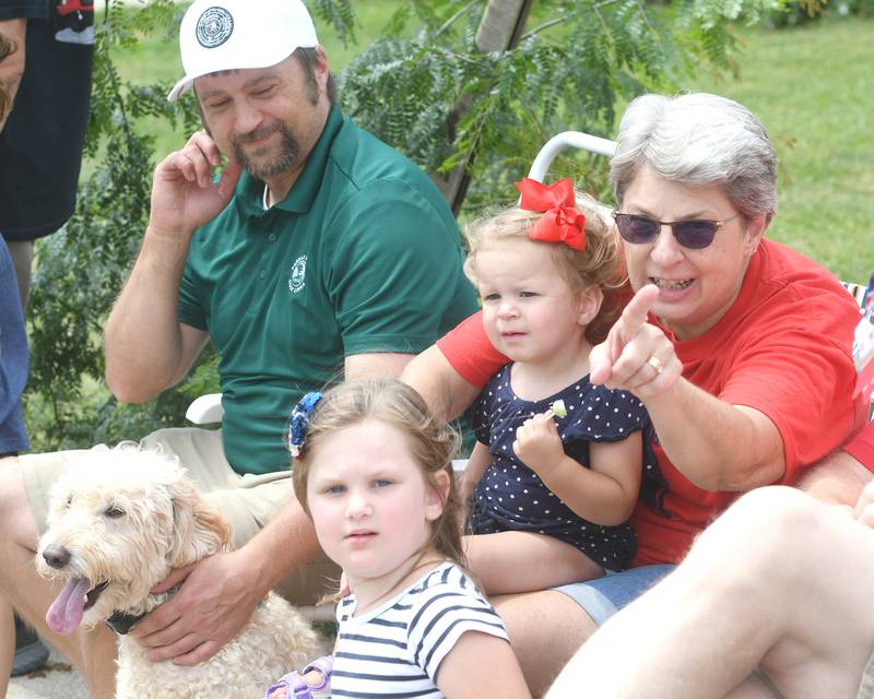 The Bramm family of Mt. Morris was at full attention as they watched the Let Freedom Ring Grand Parade on July 4 in Mt. Morris. Pictured are: Nate; Ellen; Charlotte, 2; Annabelle, 5; and Bramm, their golden doodle.