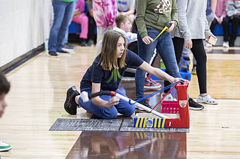 Rock Falls Middle school seventh grader Teague O’Donnell primes his catapult Friday, Dec. 15, 2023.