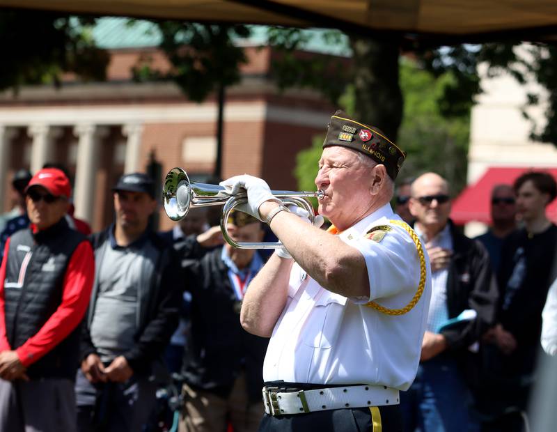 John Widmayer of VFW Post 5040 performs taps during a Memorial Day service and parade in downtown Woodstock on Monday, May 26, 2025.