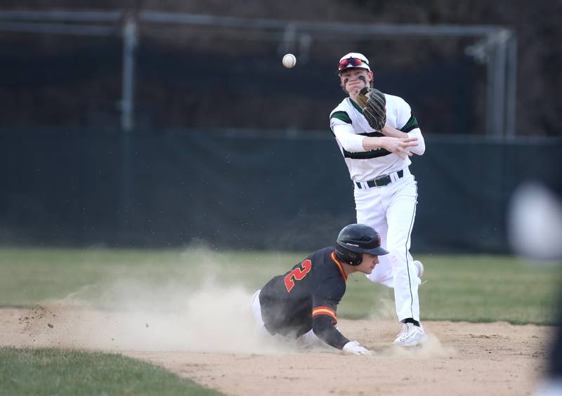 Glenbard West’s Braeden Groszek gets the out at second as Batavia’s Jacob Aseltine slides during a game at Village Green Park in Glen Ellyn on Wednesday, March 13, 2024.