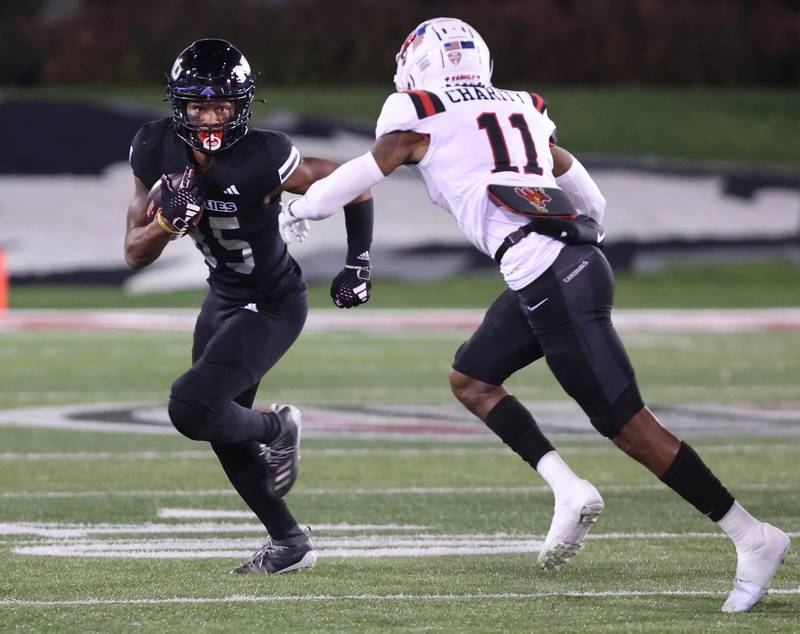 Northern Illinois' Trayvon Rudolph tries to get outside of Ball State's Damion Charity during their game Tuesday, Nov. 7, 2023, in Huskie Stadium at NIU in DeKalb.