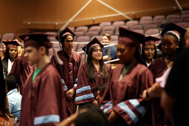 Kankakee High School graduate Jocelyn Gonzalez-Torres, center, enters the auditorium with fellow classmates during the summer commencement ceremony at the high school on Tuesday, July 29, 2025.