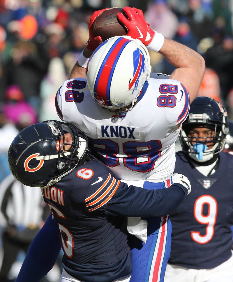 Buffalo Bills tight end Dawson Knox makes a catch despite the coverage of Chicago Bears cornerback Kyler Gordon during their game Sunday, Dec. 24, 2022, at Soldier Field in Chicago.