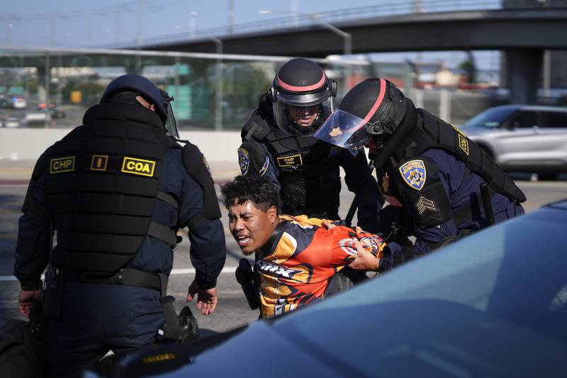 A protester is arrested by California Highway Patrol near the federal building in downtown Los Angeles on Tuesday, June 10, 2025. (AP Photo/Eric Thayer)