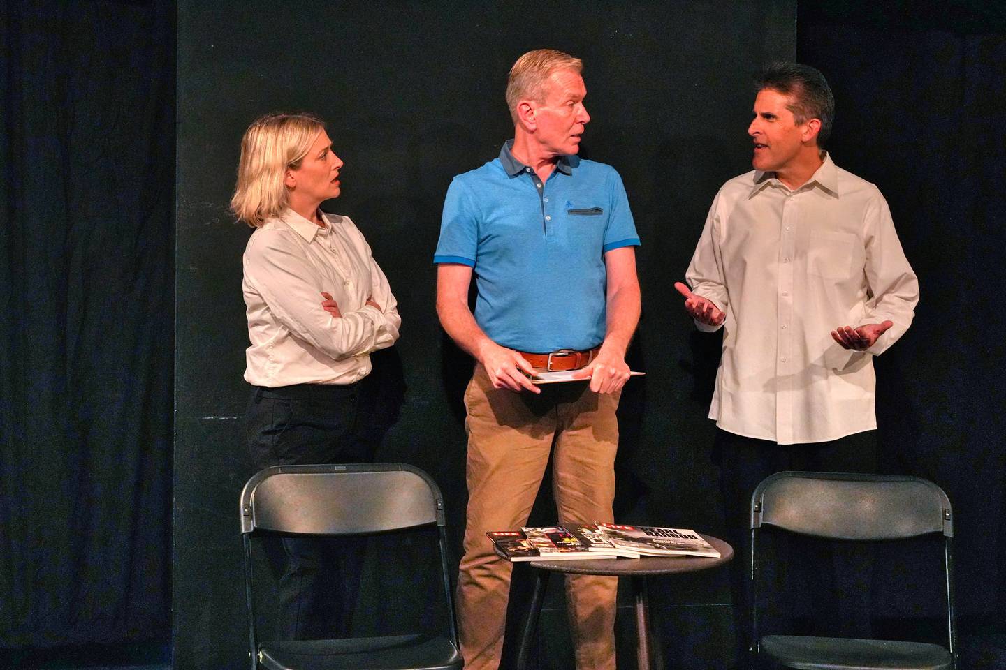 Laura (Kelly Belmont) and James (Carl Zeitler) surround Host #2 (Guy Sullivan) with their concerns in "The Second-to-Last Exit" at Village Theatre Guild [L to R: Kelly Belmont, Guy Sullivan, Carl Zeitler] [photo credit: David Dowell]