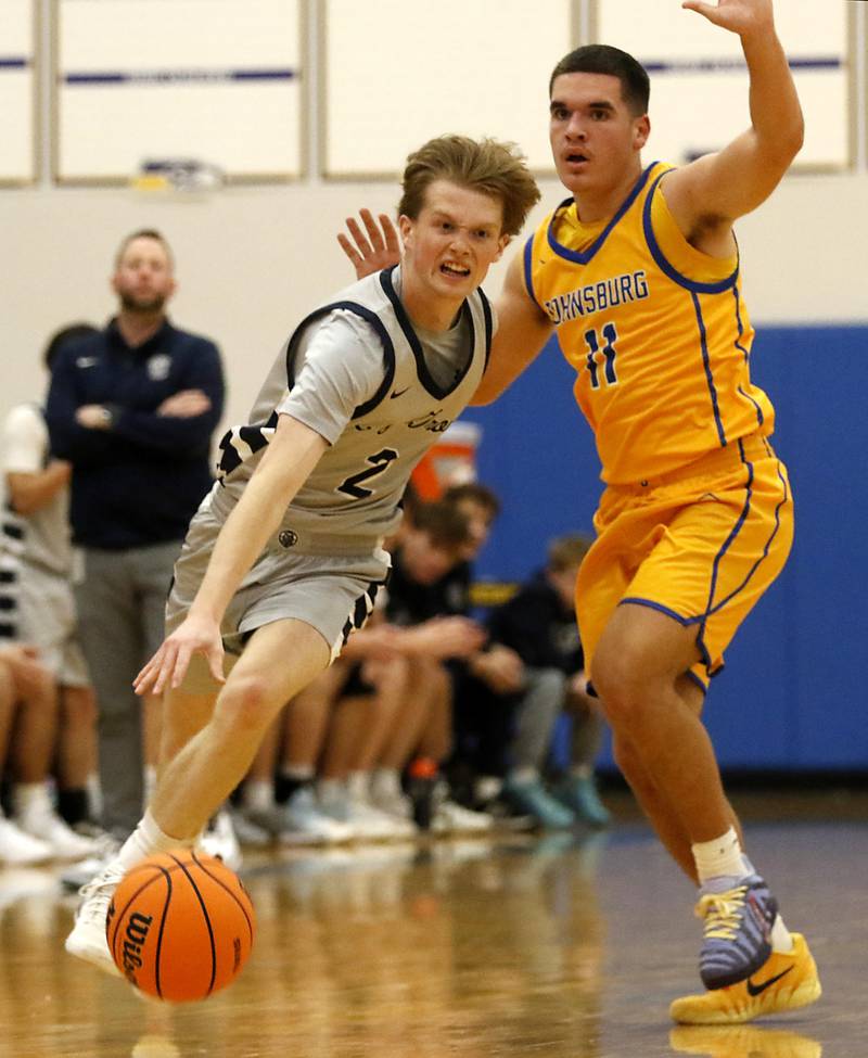 Cary-Grove's AJ Berndt pushed th ball up the court against Johnsburg's Ryan Franze during a Johnsburg Thanksgiving Tournament boys basketball game on Monday, Nov. 24, 2025, at Johnsburg High School.