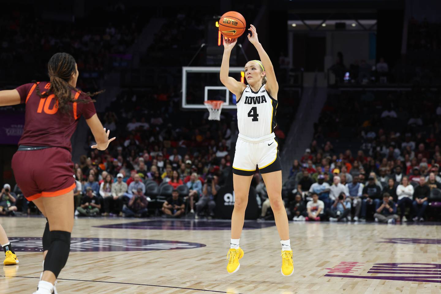 Iowa Hawkeyes guard Kylie Feuerbach shoots a 3-pointer (4) during the first quarter of their game against Virginia Tech in the Ally Tipoff at the Spectrum Center in Charlotte, North Carolina on Sunday, November 10, 2024. (Stephen Mally/hawkeyesports.com)