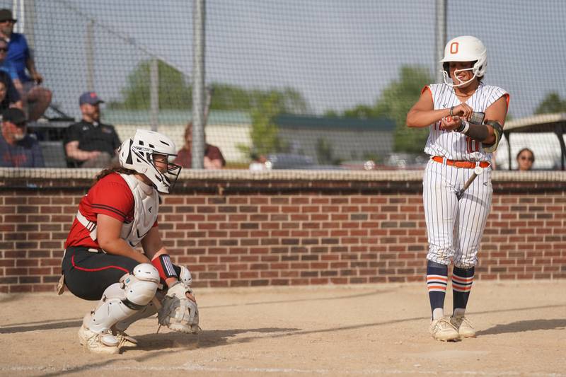 Yorkville catcher Kayla Kersting, left, and Oswego catcher Kiyah Chavez talk to one another during a softball game at Oswego High School on Thursday, May 15, 2025.