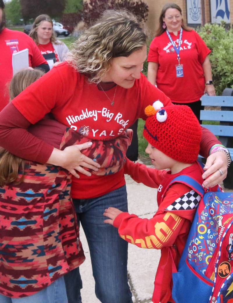 Jessica Satdei hugs her children, Marshall Morong (right) and Carolynn Morong as they head into Hinckley-Big Rock Elementary School Monday, May 5, 2025. Students gathered to welcome Marshall back to school months after receiving a heart transplant.