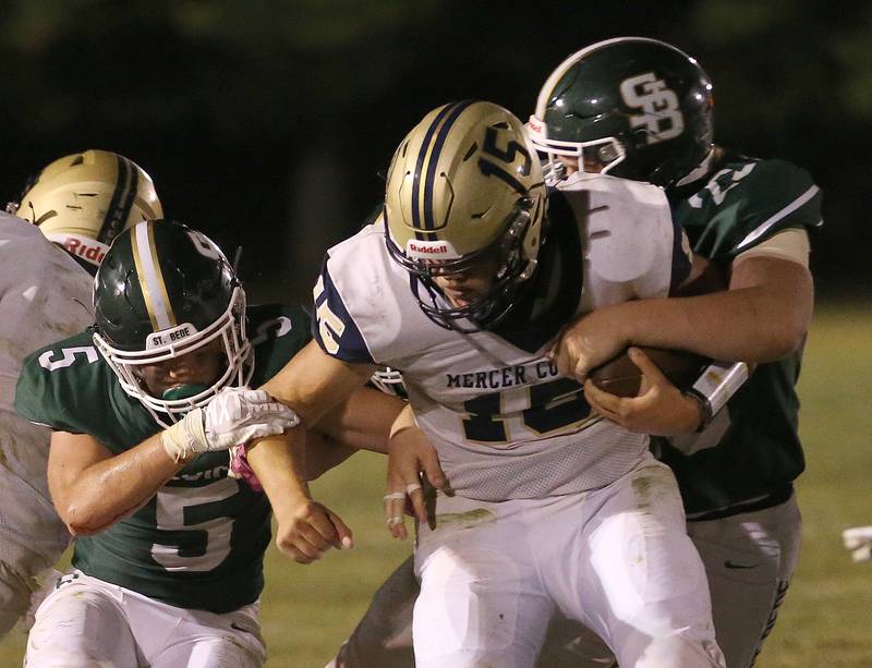 Mercer County's quarterback Colby Cox is brought down by St. Bede's Halden Hueneburg and teammate Drew Roda on Friday, Sept. 1, 2023 at St. Bede Academy.